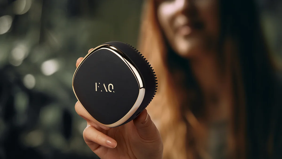 A blurred woman showing a closeup of FAQ 302 laser and red light therapy for hair growth